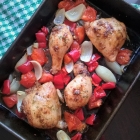 Tray-baked chicken with tomatoes, peppers and onions